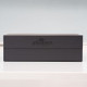 A plain black crafted gift box against a pale grey background. A plain black crafted gift box against a pale grey background.